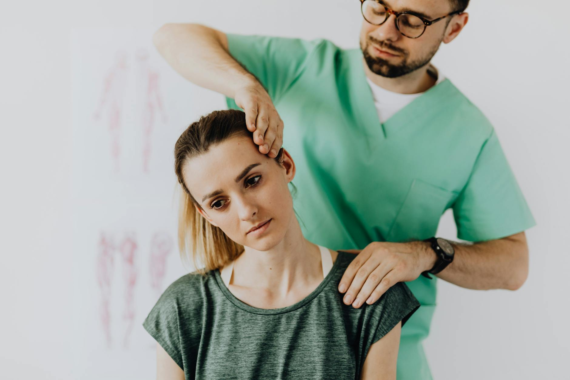 A chiropractor performs therapeutic neck adjustments on a patient for pain relief.