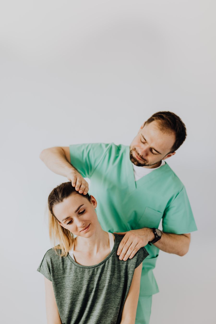 Therapist providing neck and shoulder treatment to a patient