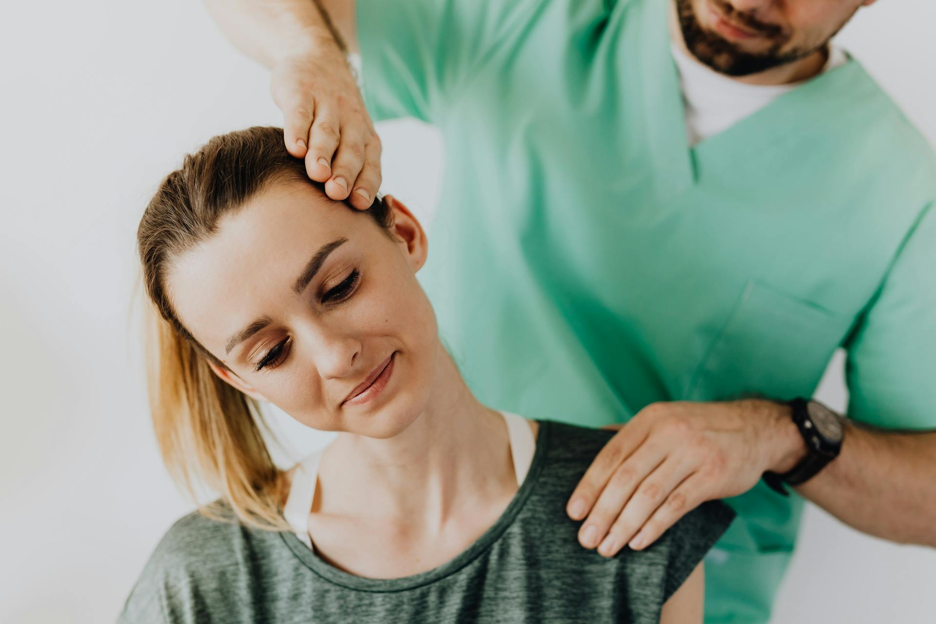 Professional Massage Therapist Treating a Female Patient's Injured Neck