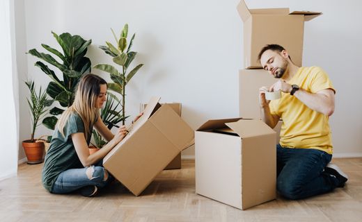 Couple packing belongings into boxes