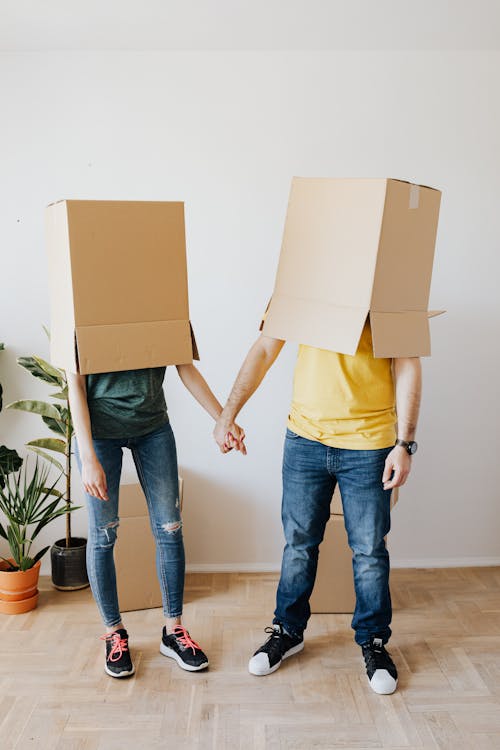 Free Funny couple with carton boxes on heads Stock Photo