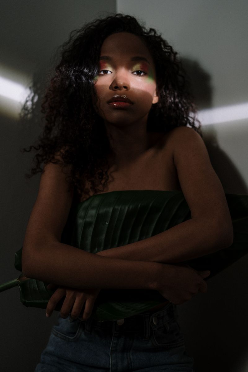Artistic portrait of a woman with curly hair in dramatic lighting