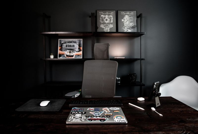 small shelf mounted above a standing desk monitor