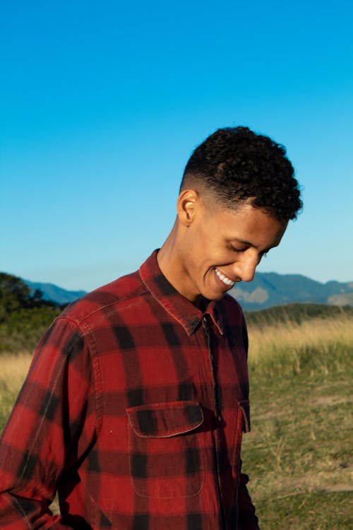 Man in Red and Black Checkered Shirt Smiling
