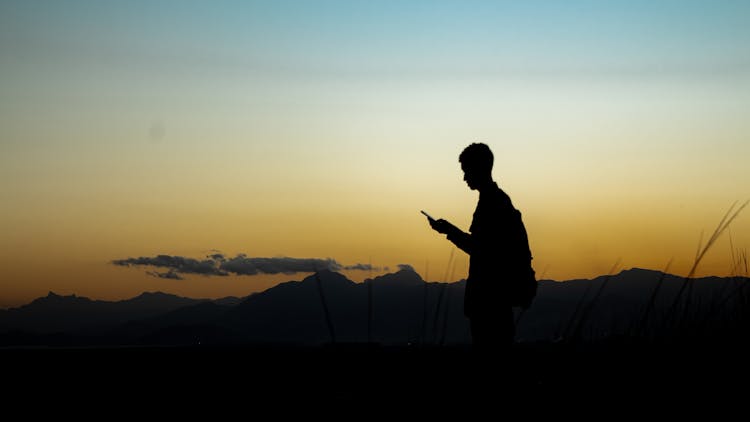 Silhouette Of Man Holding An Object