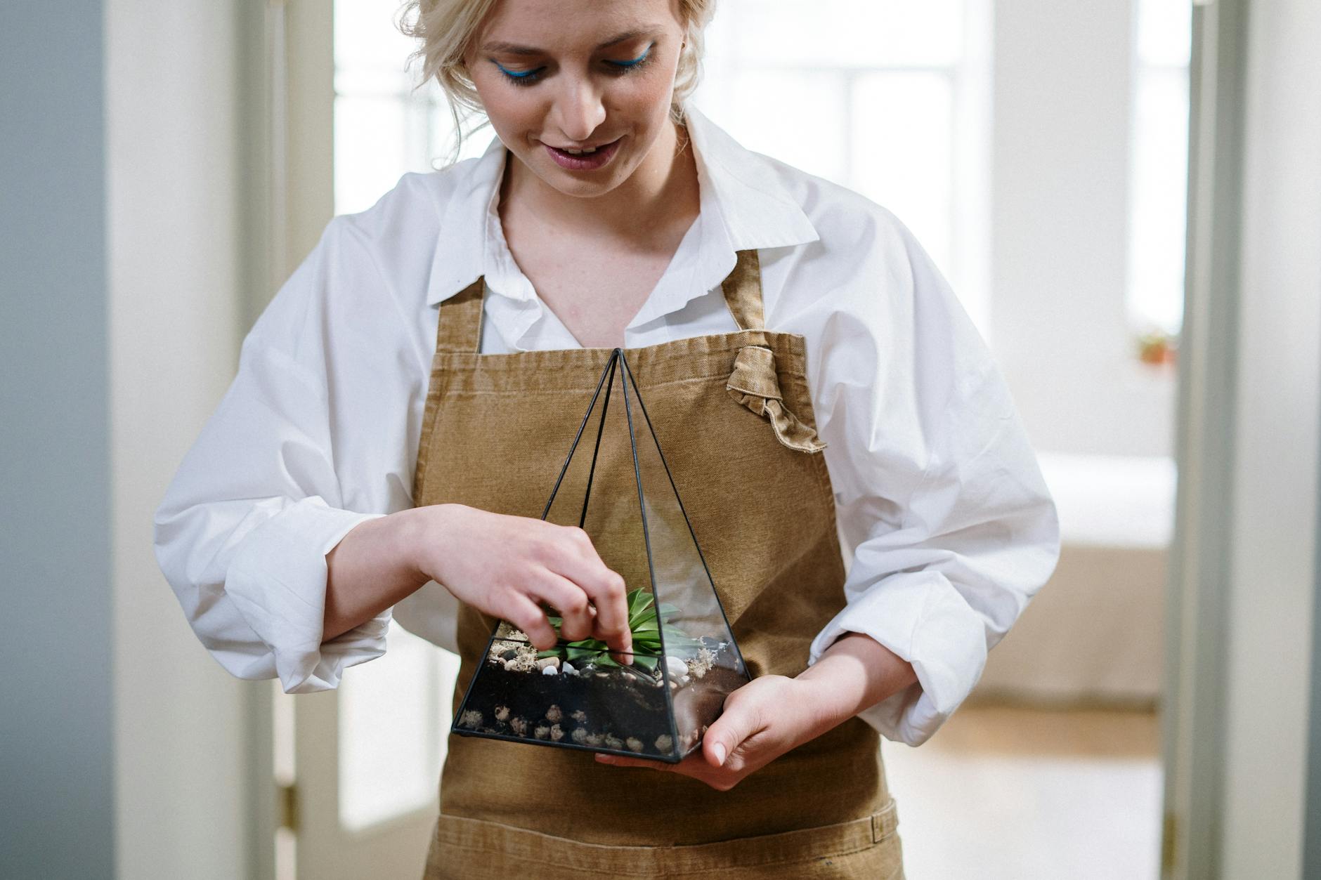 Woman in White Dress Shirt and Brown Apron Holding Brown Wooden Tray