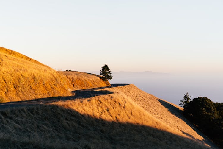 Road In The Mountain Above Clouds During Sunrise