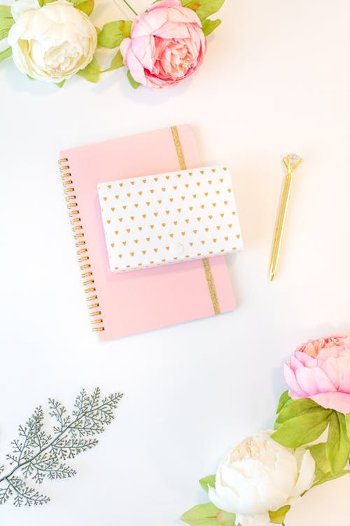 Pink Notebook and White and Pink Roses on White Background