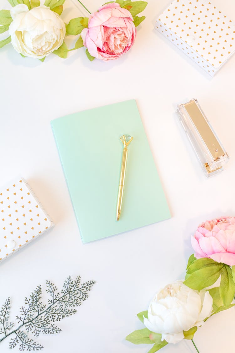 Teal Notebook And White And Pink Roses On White Background