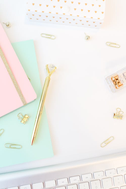 Free Golden Pen, Notepads and Keyboard on White Background Stock Photo