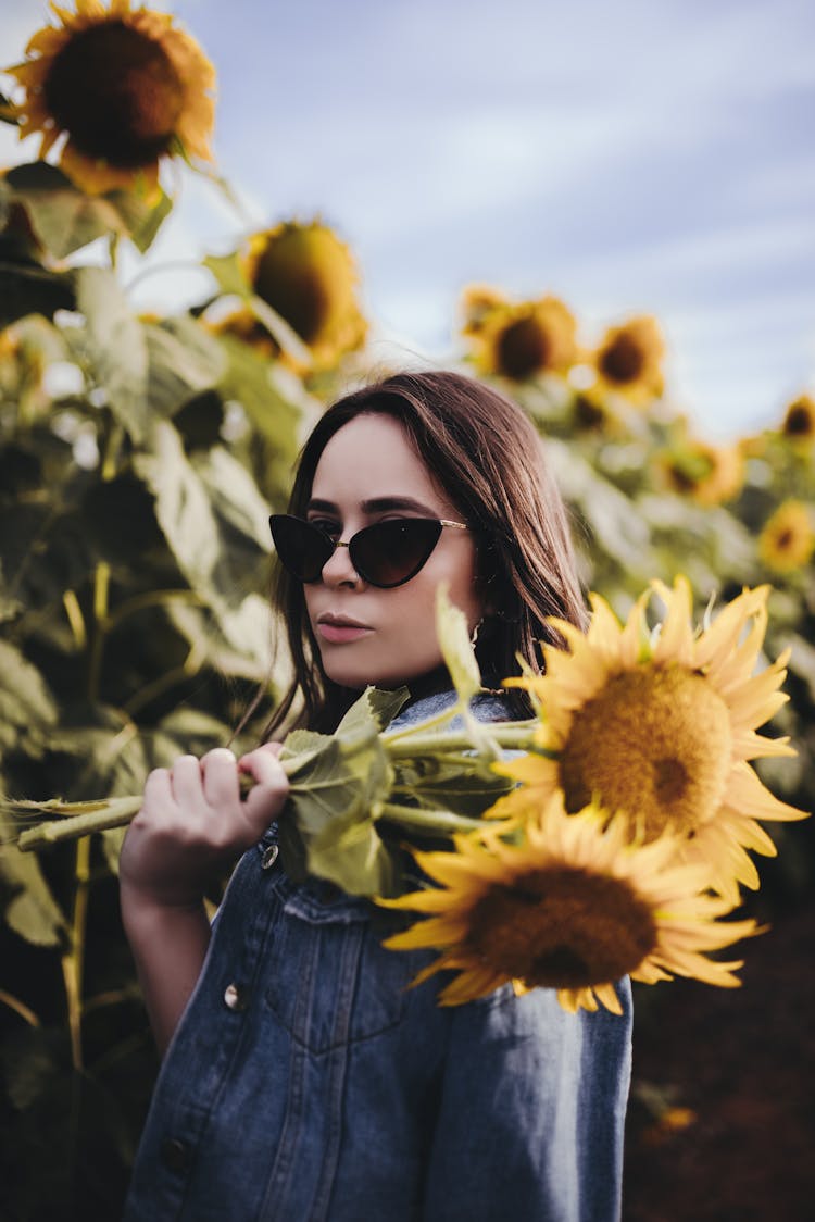 Calm Woman Standing In Sunflower Field