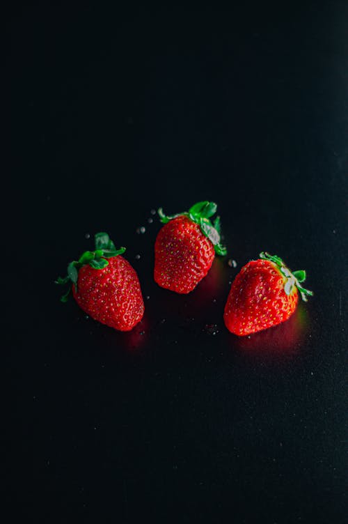 Ripe strawberries placed on black table