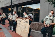 Person Protesting next to Cops