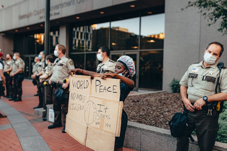 Person Protesting Next To Cops