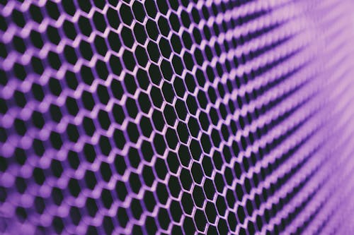 Free Abstract geometric texture of purple metallic net on dark background Stock Photo