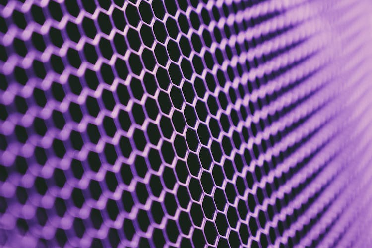 Abstract Geometric Texture Of Purple Metallic Net On Dark Background