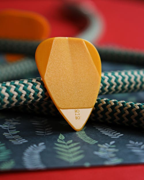 Close-Up Photo of Yellow Guitar Pick