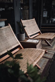 Cozy rattan chairs with a potted plant at a rustic cafe in Wagga Wagga, NSW.