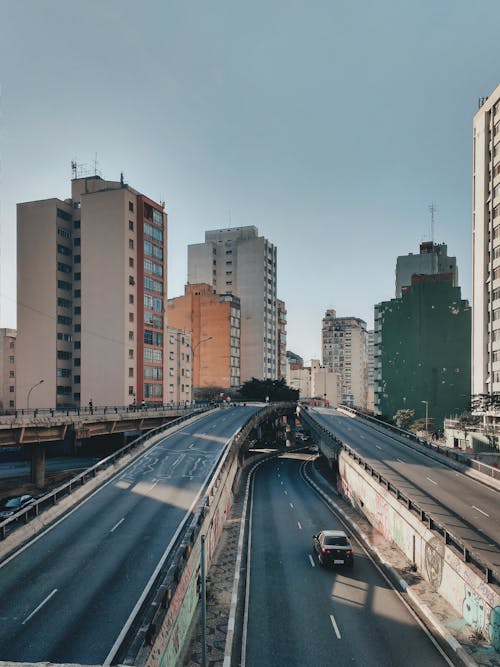 Free Car on Road Near Buildings Stock Photo