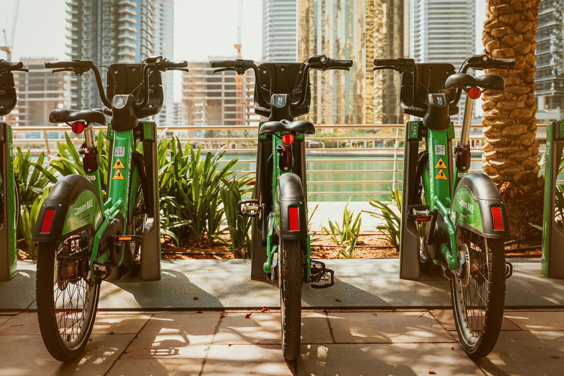 Careem bikes parked in Dubai Marina on a sunny day, showcasing modern urban transportation.