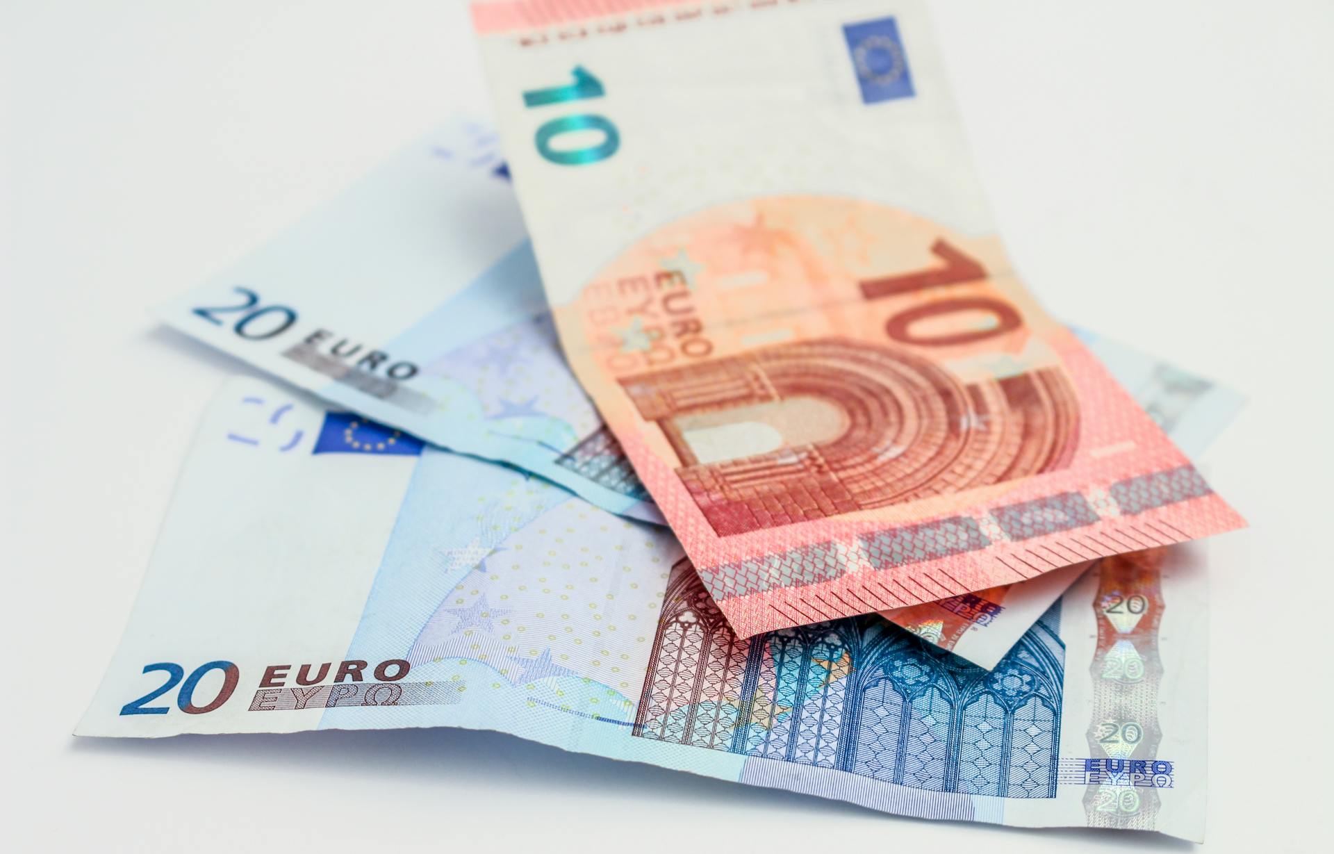 Stack of 10 and 20 euro banknotes symbolizing finance and economy.