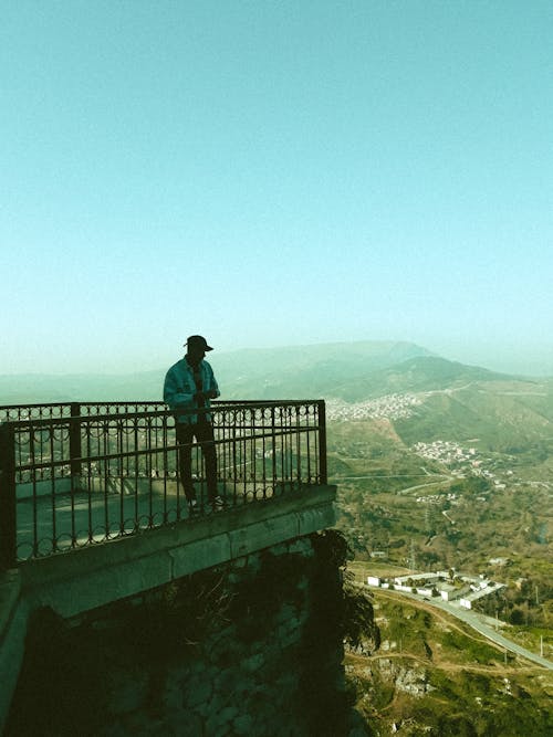 Anonymous male tourist enjoying landscape from viewing platform