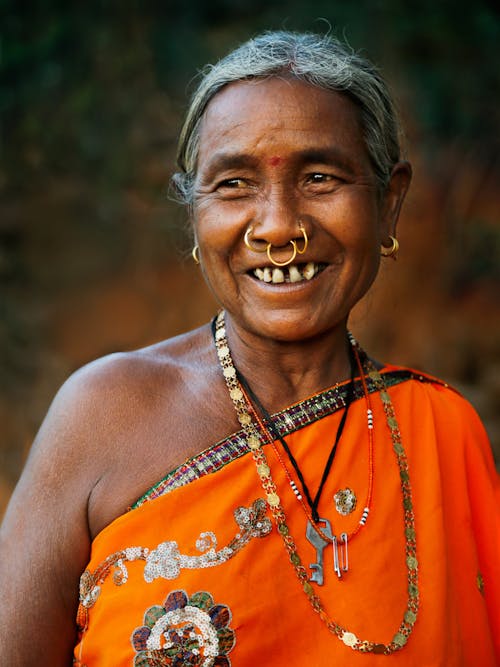 Woman in Orange Floral Sleeveless Dress Smiling