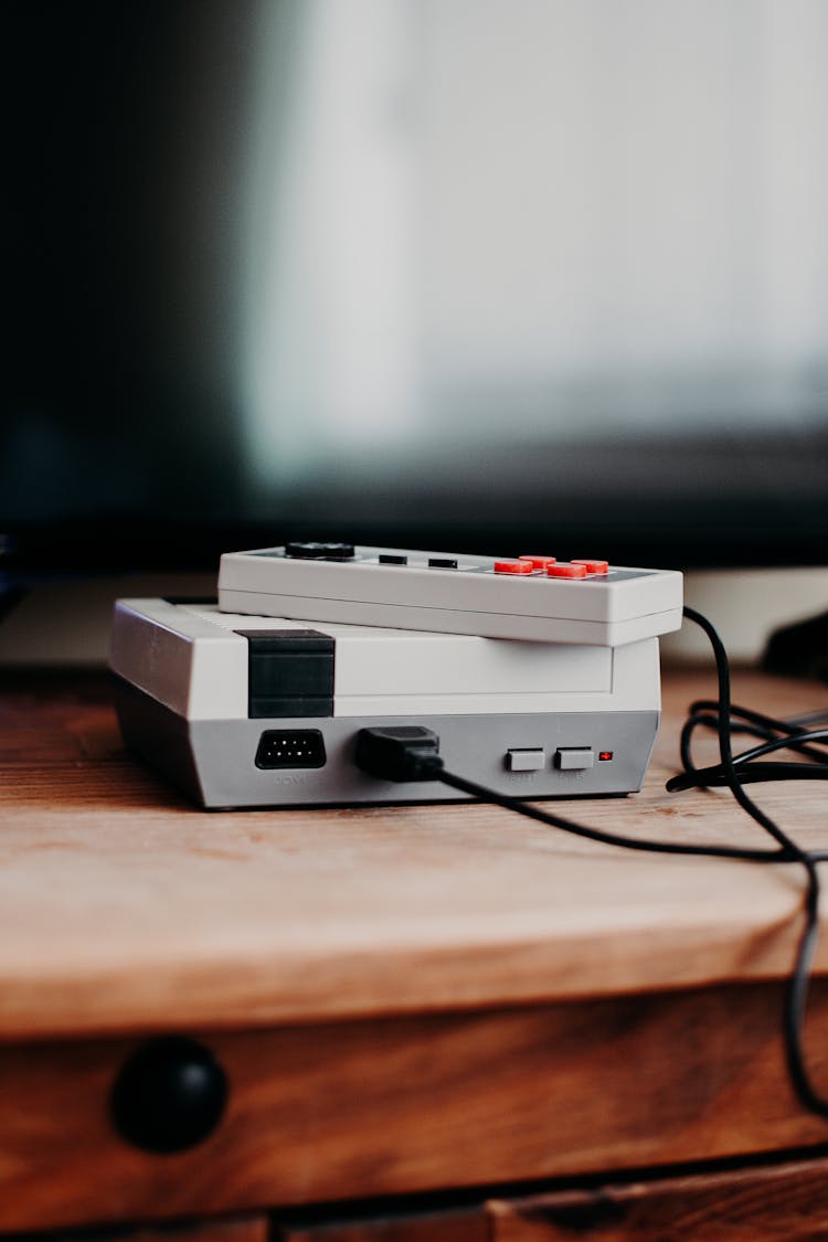 Photo Of Video Game Console On Brown Wooden Table