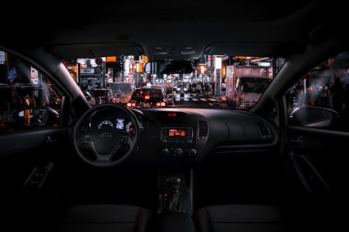Black Car Steering Wheel and Interior during Night Time