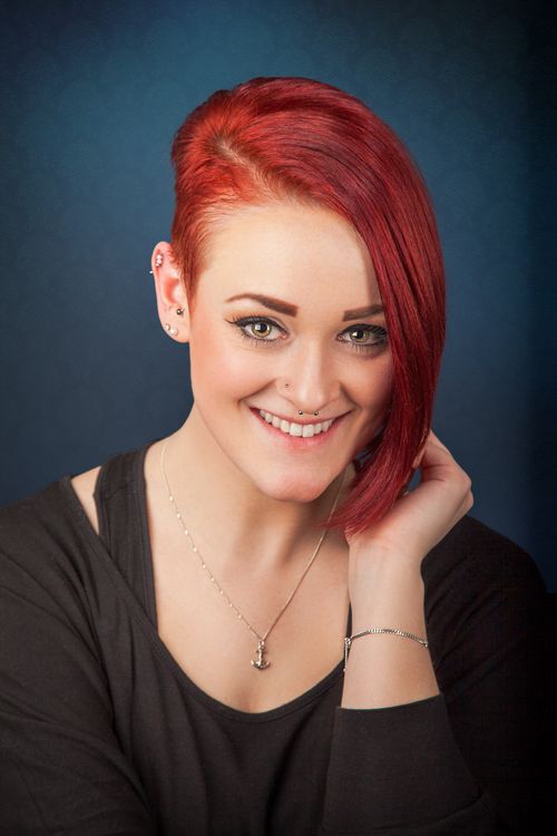 Free Studio portrait of a smiling woman with red hair and modern style. Stock Photo