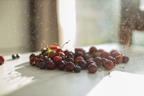 Red Round Fruits on White Table