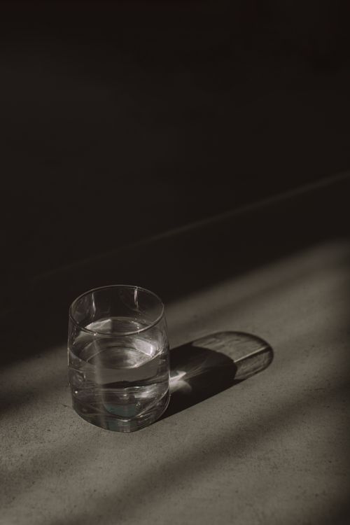 Free A minimalist composition showing a glass of water casting shadows, showcasing simple elegance. Stock Photo