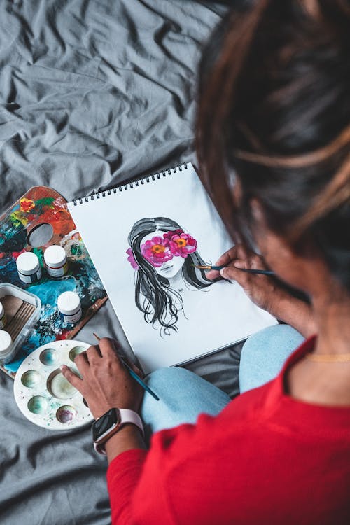 Photo of Person Painting on White Paper