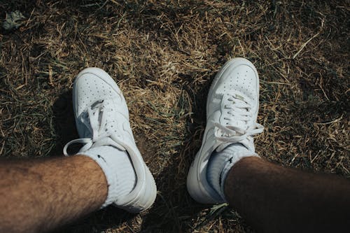 Free Person Wearing White Nike Sneakers Stock Photo