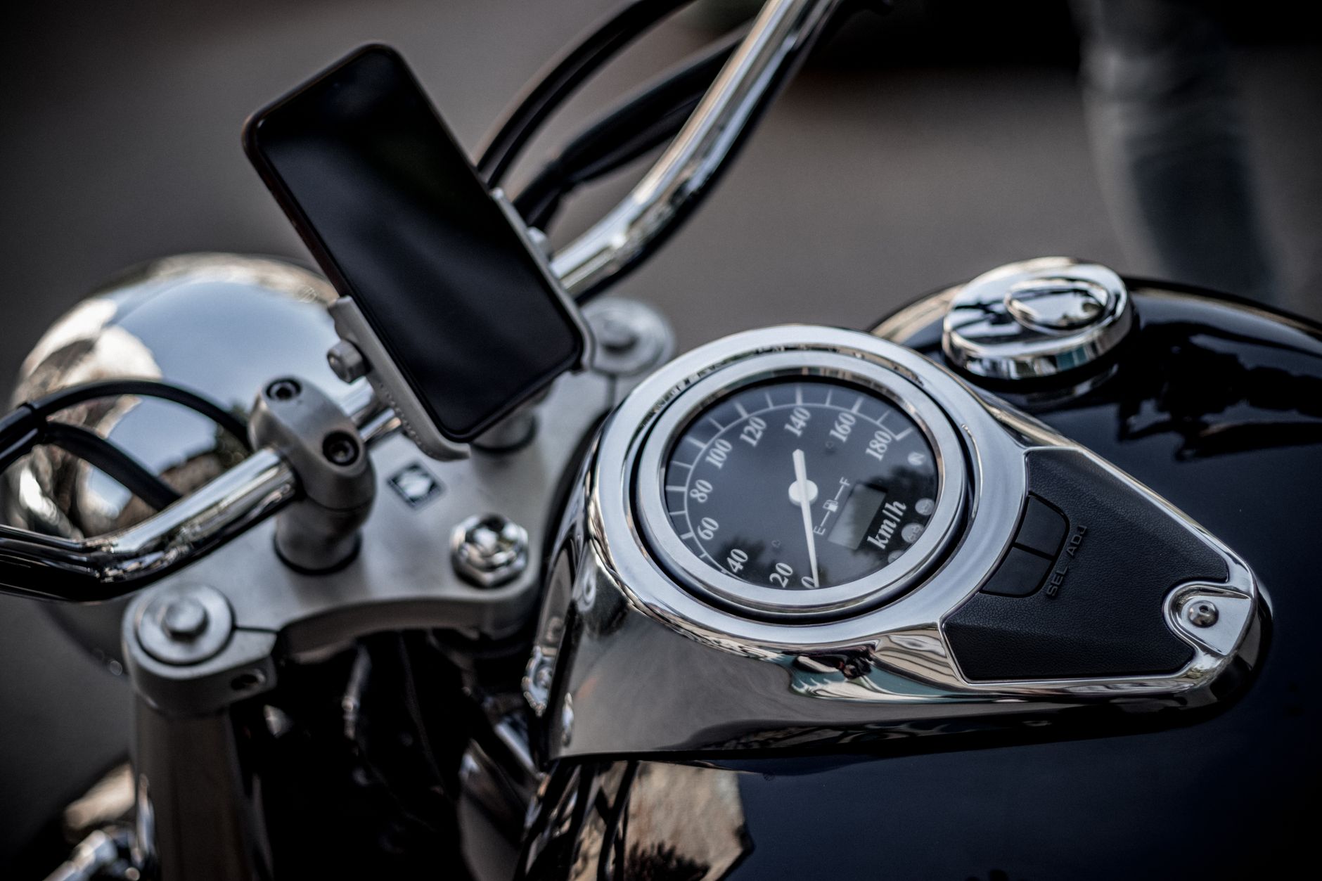High-angle view of a motorcycle's speedometer and smartphone mount, capturing the essence of modern biking.
