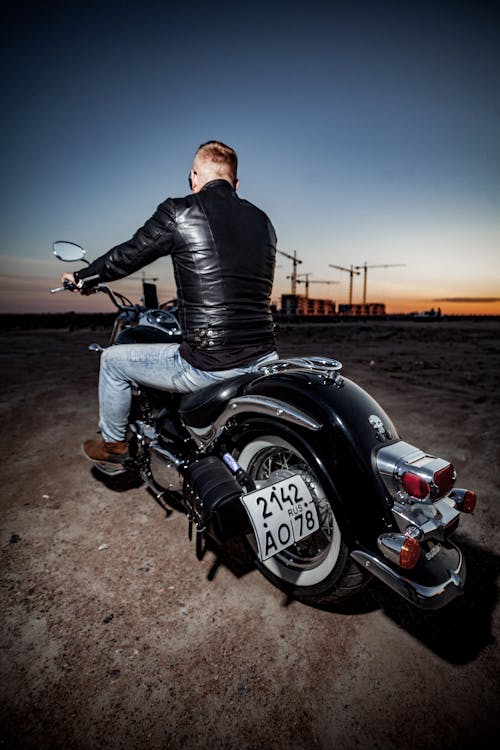 Free Man in Black Leather Jacket Riding Black Motorcycle Stock Photo