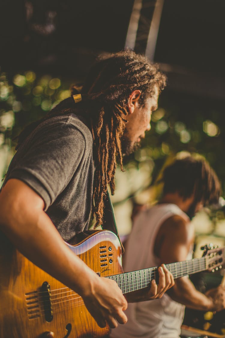 Man In Black T-shirt Playing Brown Electric Guitar