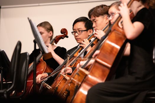 Group of skilled cellists focused during a classical concert performance.