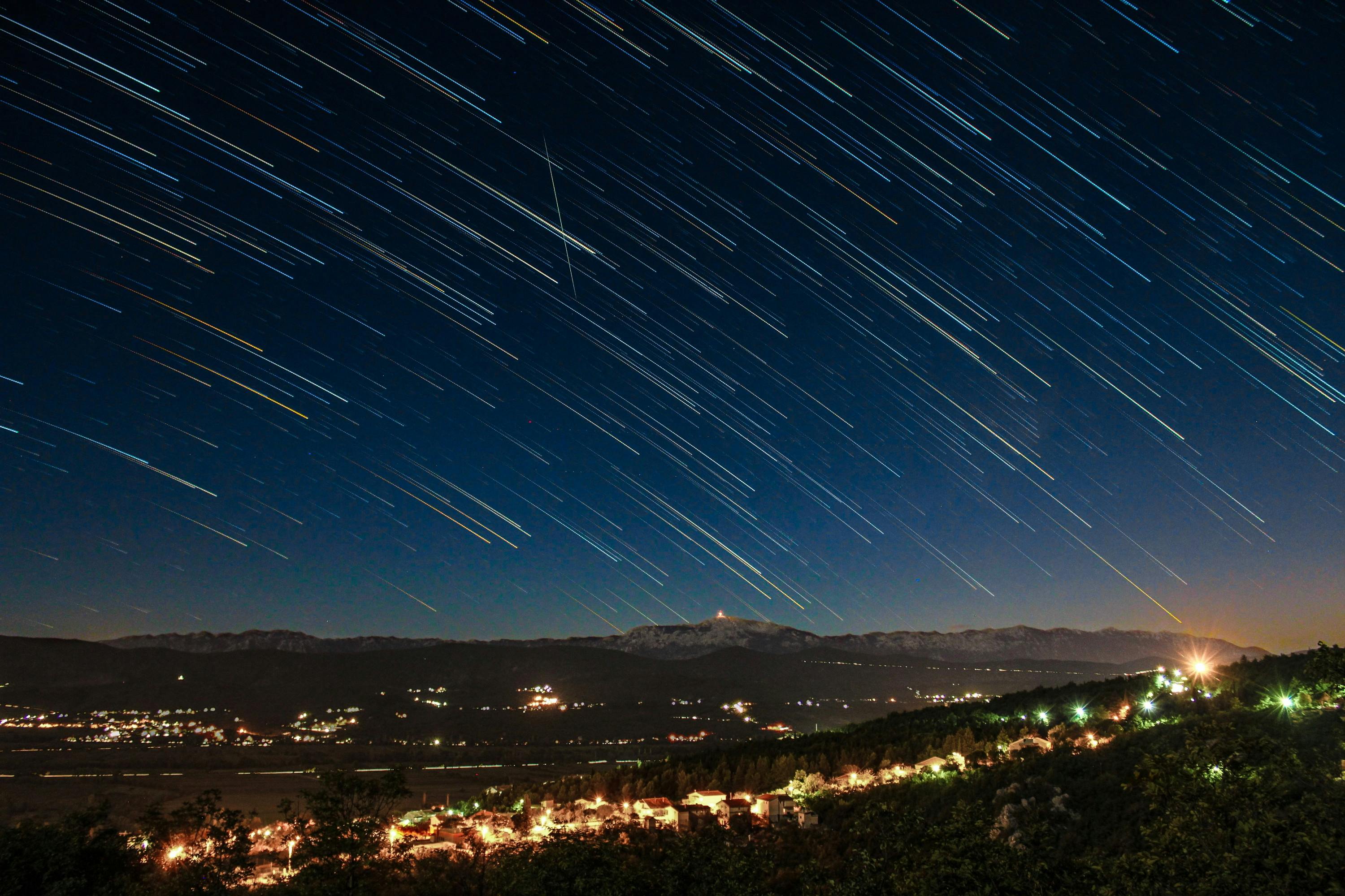 Stunning long exposure of star trails over a village in Croatia at night.