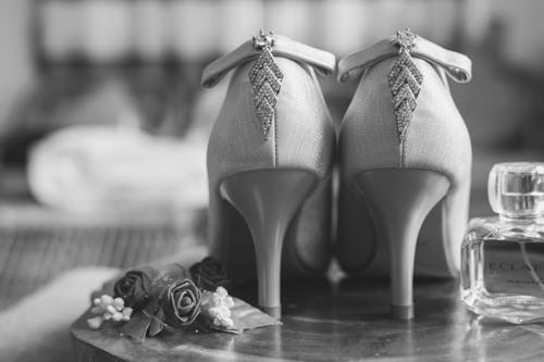 Grayscale Photo of Pair of Open Toe Pumps