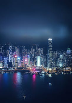 Discover the breathtaking nighttime view of Hong Kong's illuminated skyline across Victoria Harbour.