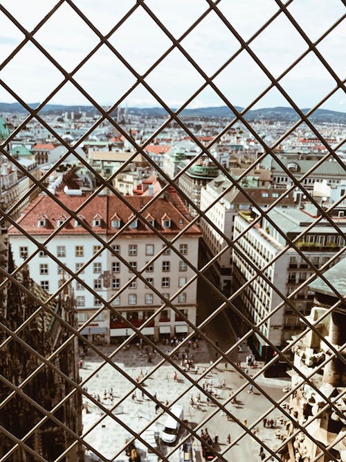 Photo of Chain-Link Fence Against City Background