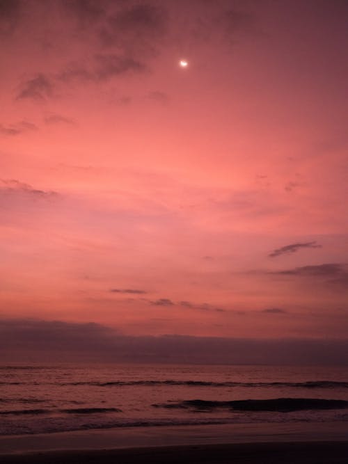 Red sunset sky over sea waves