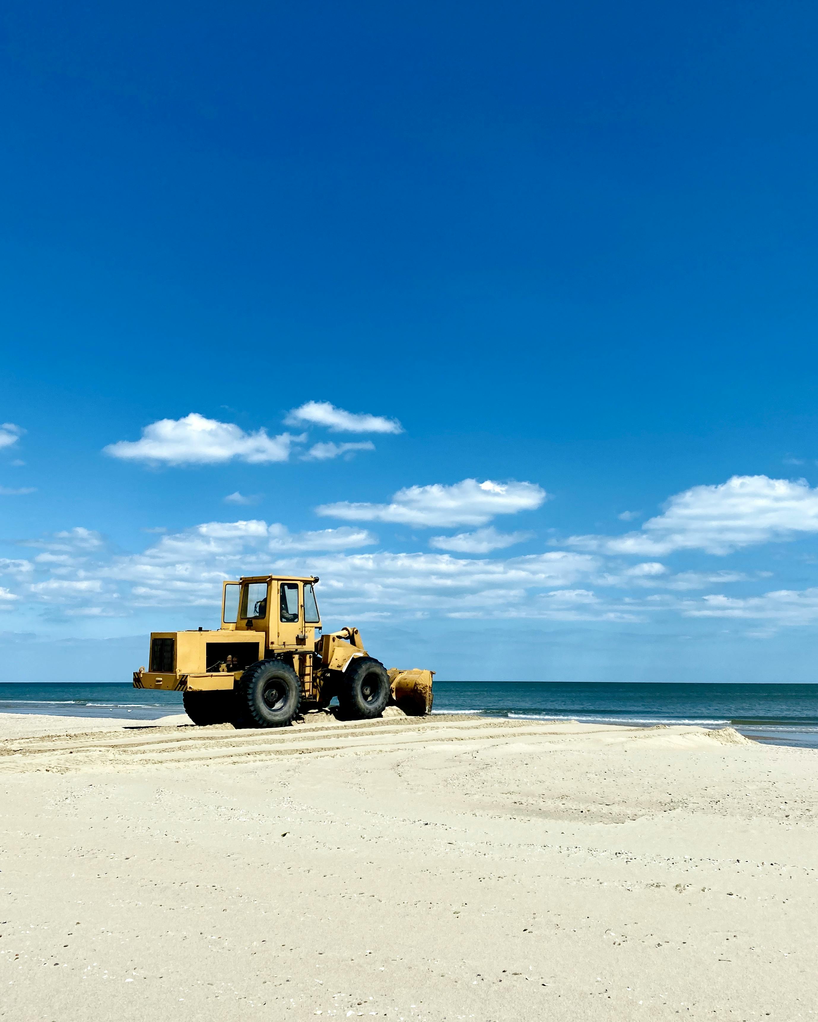 sand cleaning machine on seashore on sunny day