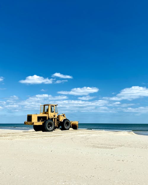 Sand cleaning machine on seashore on sunny day