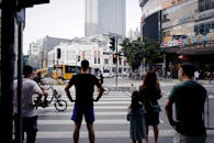Unrecognizable people standing on crosswalk in downtown
