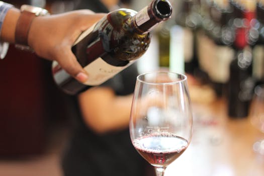 Close-up of red wine being poured into a glass in a Cape Town restaurant.