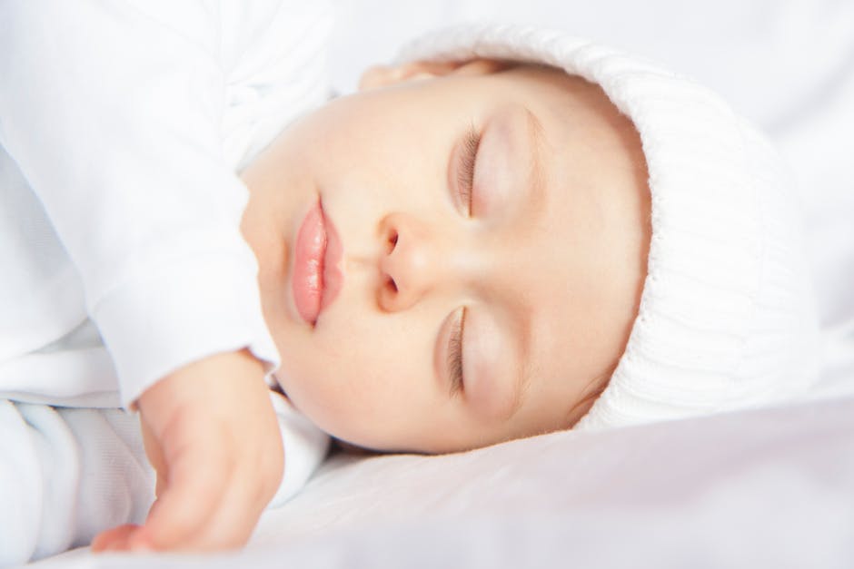5 Hidden White Noise Machine Features for Better Sleep A serene image of a baby sleeping peacefully in soft lighting, conveying innocence and calm.