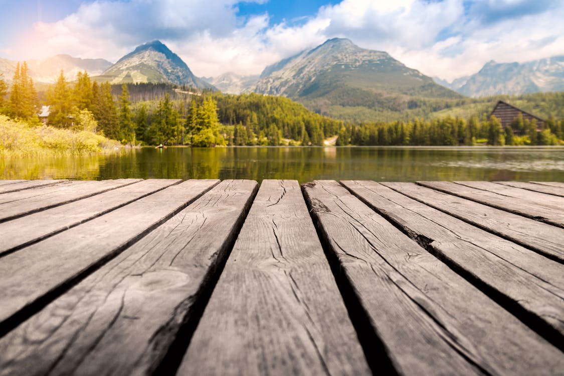 Free Body of Water Near Mountain Range Stock Photo