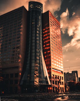 Stunning shot of a modern skyscraper in Warsaw reflecting dramatic sunset hues.